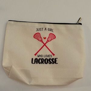NWOT white zipper pouch with Lacrosse theme.